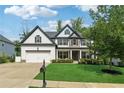Charming two-story home featuring stone accents, a manicured lawn, and a two-car garage at 236 Lakestone Pkwy, Woodstock, GA 30188