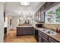 Open kitchen featuring granite counters, stainless appliances, tile backsplash, and wood floors at 9055 Green Valley Ct, Douglasville, GA 30134