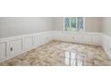 Bright, carpeted room with decorative molding, offering a clean and elegant space for living or dining at 9055 Green Valley Ct, Douglasville, GA 30134