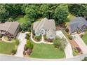 Aerial view of a home featuring a lush lawn, mature trees, and circular driveway at 1345 Benbrooke Nw Ln, Acworth, GA 30101