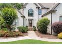 Inviting front entrance with a well-kept lawn and lovely landscaping at 1345 Benbrooke Nw Ln, Acworth, GA 30101