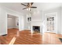 Bright living room with hardwood floors, a painted brick fireplace, and great natural light at 1015 Deckner Sw Ave, Atlanta, GA 30310
