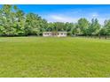 Picturesque view of a well-maintained home surrounded by a lush green lawn and a classic wooden fence at 146 Henderson Farm Ln, Canton, GA 30115