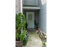 Warm, inviting entrance with charming decor, featuring plants and walkway lights at 5590 Stonewood Court Ct, Norcross, GA 30093