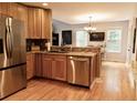 Well-equipped kitchen with stainless steel appliances, light wood cabinets, and hardwood floors at 9176 Lakeview Pkwy, Villa Rica, GA 30180
