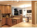 Open kitchen with granite countertops, stainless steel appliances, and hardwood floors at 9176 Lakeview Pkwy, Villa Rica, GA 30180
