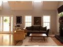 Bright living room with high ceilings, a cozy fireplace, and natural light from large windows at 9176 Lakeview Pkwy, Villa Rica, GA 30180