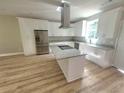Modern kitchen boasts stainless steel appliances, granite countertops, and an island at 7241 Grayson Dr, Riverdale, GA 30296
