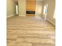 Bright living room featuring wood-look floors and a contemporary fireplace design at 7241 Grayson Dr, Riverdale, GA 30296