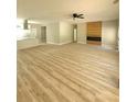 Spacious living room with wood-look flooring and a modern electric fireplace at 7241 Grayson Dr, Riverdale, GA 30296
