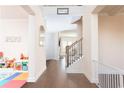 Bright foyer featuring hardwood floors, a staircase with iron railings, and views into other living spaces at 905 Eldridge Rd, Hampton, GA 30228