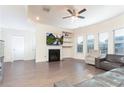 Spacious living room with hardwood floors, fireplace, a ceiling fan, and plenty of natural light at 905 Eldridge Rd, Hampton, GA 30228