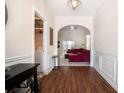 Inviting hallway with rich wood flooring and arched entryway leading to the living area at 1856 Temple Park Dr, Loganville, GA 30052
