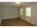 Bright living room features wood-look floors and sun-filled windows at 5512 Arrowhead Dr, Acworth, GA 30102