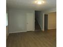 Open living room has wood floors, neutral walls, and a staircase to upper level at 5512 Arrowhead Dr, Acworth, GA 30102