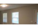 Bright living room features wood-look floors and sun-filled windows at 5512 Arrowhead Dr, Acworth, GA 30102
