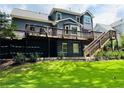 Large wooden deck overlooking a lush backyard with walkout basement at 735 Jamie Ne Way, Woodstock, GA 30188