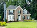 Attractive two-story brick home with a well manicured lawn and tasteful landscaping at 735 Jamie Ne Way, Woodstock, GA 30188