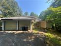 Detached two-car garage features dual doors and a concrete driveway on a sunny day at 975 Willeo Rd, Roswell, GA 30075