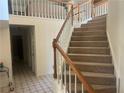Carpeted staircase with white spindles and wood railing leads to the second level at 975 Willeo Rd, Roswell, GA 30075