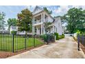 Beautiful two-story home with a gated driveway and well-maintained landscaping at 1505 Walker Ave, College Park, GA 30337