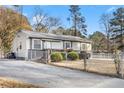Charming single-story home featuring a covered front porch, neutral siding, a driveway and a chain link fence at 1035 Stonewall Se Dr, Atlanta, GA 30315