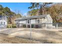 Charming single-story home featuring a covered front porch, neutral siding, and well-maintained landscaping with chain link fence at 1035 Stonewall Se Dr, Atlanta, GA 30315