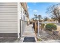 Side entrance of home with a wooden ramp and a chain-link fence at 1035 Stonewall Se Dr, Atlanta, GA 30315