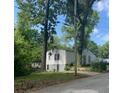 View of the side and back of a one-story house surrounded by mature trees at 1762 Hadlock Street Southwest, Atlanta, GA 30311