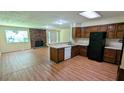 Open kitchen area features laminate floors and a view of the brick fireplace at 3985 Lindsey Dr, Decatur, GA 30035