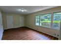 Bright living room boasts a large window, wood-look floors and neutral paint at 3985 Lindsey Dr, Decatur, GA 30035