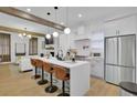 Modern kitchen with white cabinetry, stainless steel appliances, and a center island with bar seating at 701 Smith St, Atlanta, GA 30310