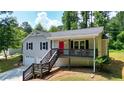 Charming two-story home with a bright red front door and a front porch at 276 Indian Creek Dr, Powder Springs, GA 30127