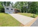 Charming two-story home with a bright red front door, two-car garage, and a long driveway at 276 Indian Creek Dr, Powder Springs, GA 30127
