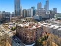 A full exterior shot of a brick apartment building in a gorgeous city setting at 115 W Peachtree Nw Pl # 602, Atlanta, GA 30313