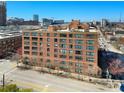 Beautiful apartment building with red brick, large windows and green awnings above ground level at 115 W Peachtree Nw Pl # 602, Atlanta, GA 30313