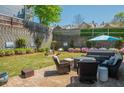 Inviting backyard oasis with a patio, hot tub, manicured lawn, retaining wall, and colorful flowerbeds at 2075 Old Georgian Nw Ter, Atlanta, GA 30318