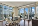 Modern dining room with floor-to-ceiling windows and access to balcony and city views at 3325 Piedmont Ne Rd # 2501, Atlanta, GA 30305