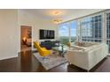 Comfortable living room with skyline view, modern furniture, and open access to the bedroom at 3325 Piedmont Ne Rd # 2501, Atlanta, GA 30305