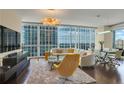 Open-concept living room with floor-to-ceiling windows and stylish contemporary furnishings at 3325 Piedmont Ne Rd # 2501, Atlanta, GA 30305