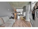 A cozy living room featuring hardwood floors, grey walls, and an open layout connected to the modern kitchen at 361 17Th St # 1121, Atlanta, GA 30363