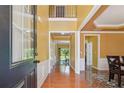 Inviting foyer featuring hardwood floors, high ceilings, and a view into the home at 8965 Friarbridge Dr, Suwanee, GA 30024