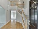 Grand foyer with hardwood floors, a staircase with white railings, and a view into the adjacent living space at 1024 Cromwell Pt, Snellville, GA 30078