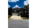 Charming brick two-story home featuring a two-car garage and a covered front porch at 2748 Farmstead Ct, Grayson, GA 30017