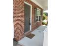 Welcoming front porch with brick detail, a 'Hey Y'all' doormat, and stylish exterior lighting at 2748 Farmstead Ct, Grayson, GA 30017