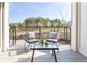 Private outdoor balcony provides a tranquil space with a view of the surrounding landscape at 7220 Summit Pl, Alpharetta, GA 30009