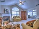 Comfortable living room featuring a fireplace, vaulted ceiling, plush seating, and a view to the sunroom at 2730 Vintage Reserve Ln, Marietta, GA 30066