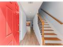 Inviting entryway features a staircase with decorative railing and sleek wood laminate flooring at 2886 Webb Bridge Rd, Alpharetta, GA 30009