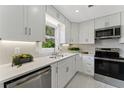Modern kitchen with white cabinets, stainless steel appliances, and elegant countertops at 2886 Webb Bridge Rd, Alpharetta, GA 30009
