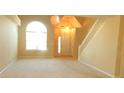 Bright living room boasting large windows, plush carpeting, and staircase, creating a warm and welcoming atmosphere at 4232 Kensington Cv, Atlanta, GA 30349